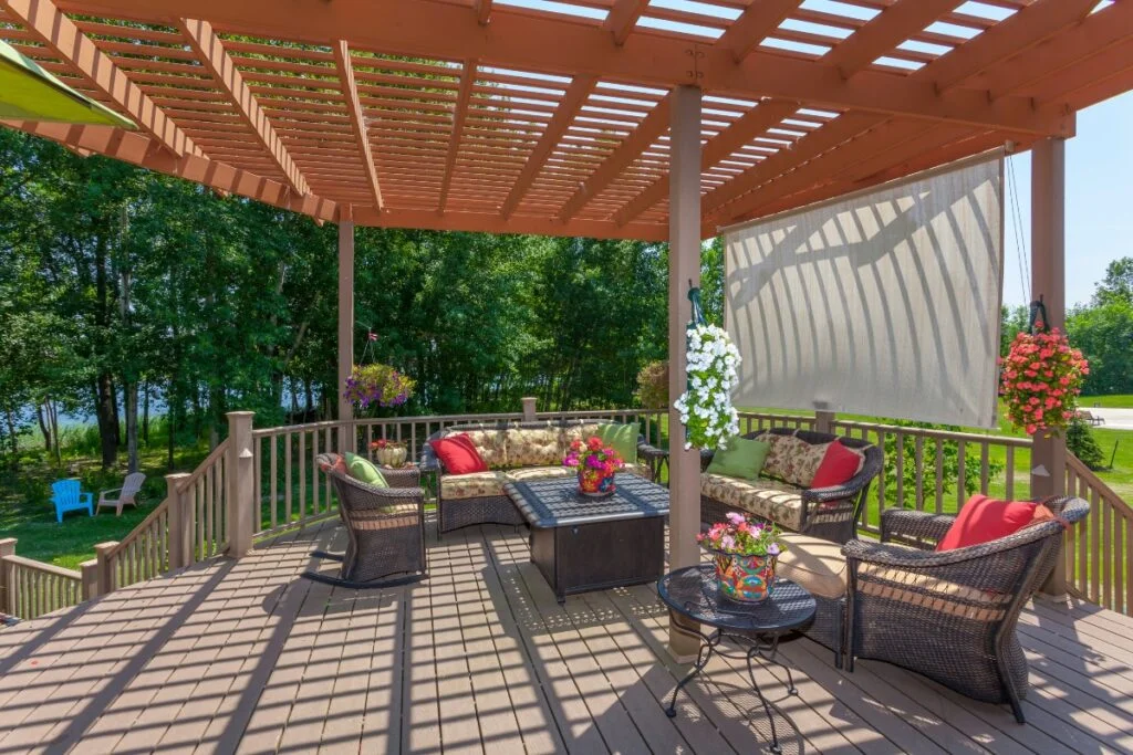Backyard patio with furniture and a pergola.