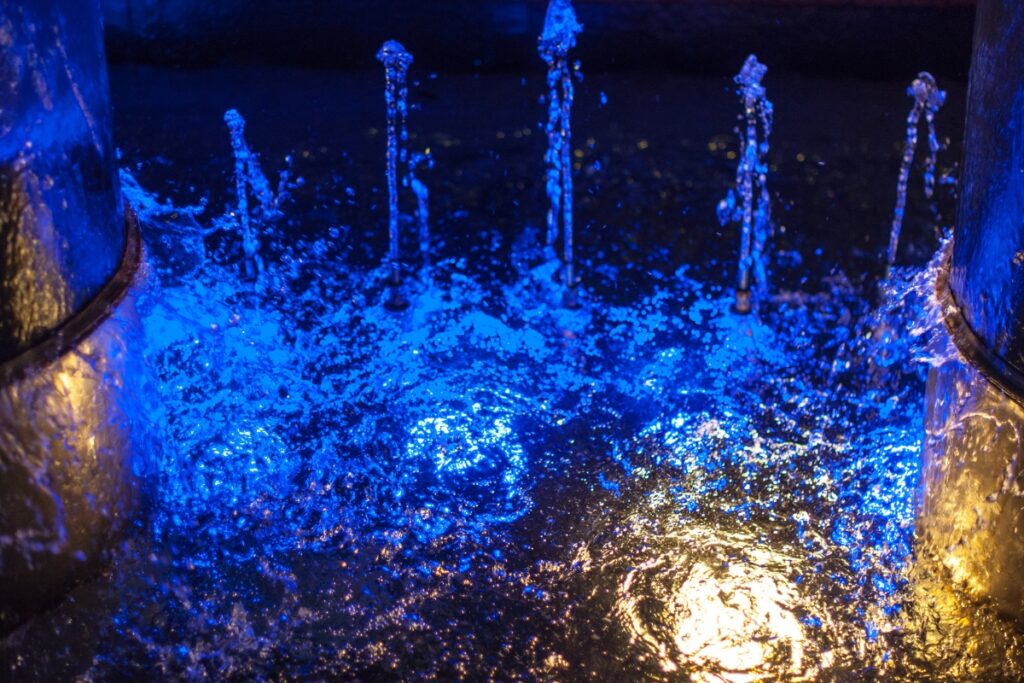 A fire hydrant enhanced with blue lights, showcasing the latest water feature trends.