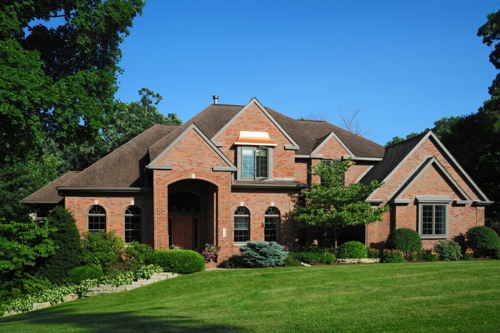 A large brick house with yard grading.
